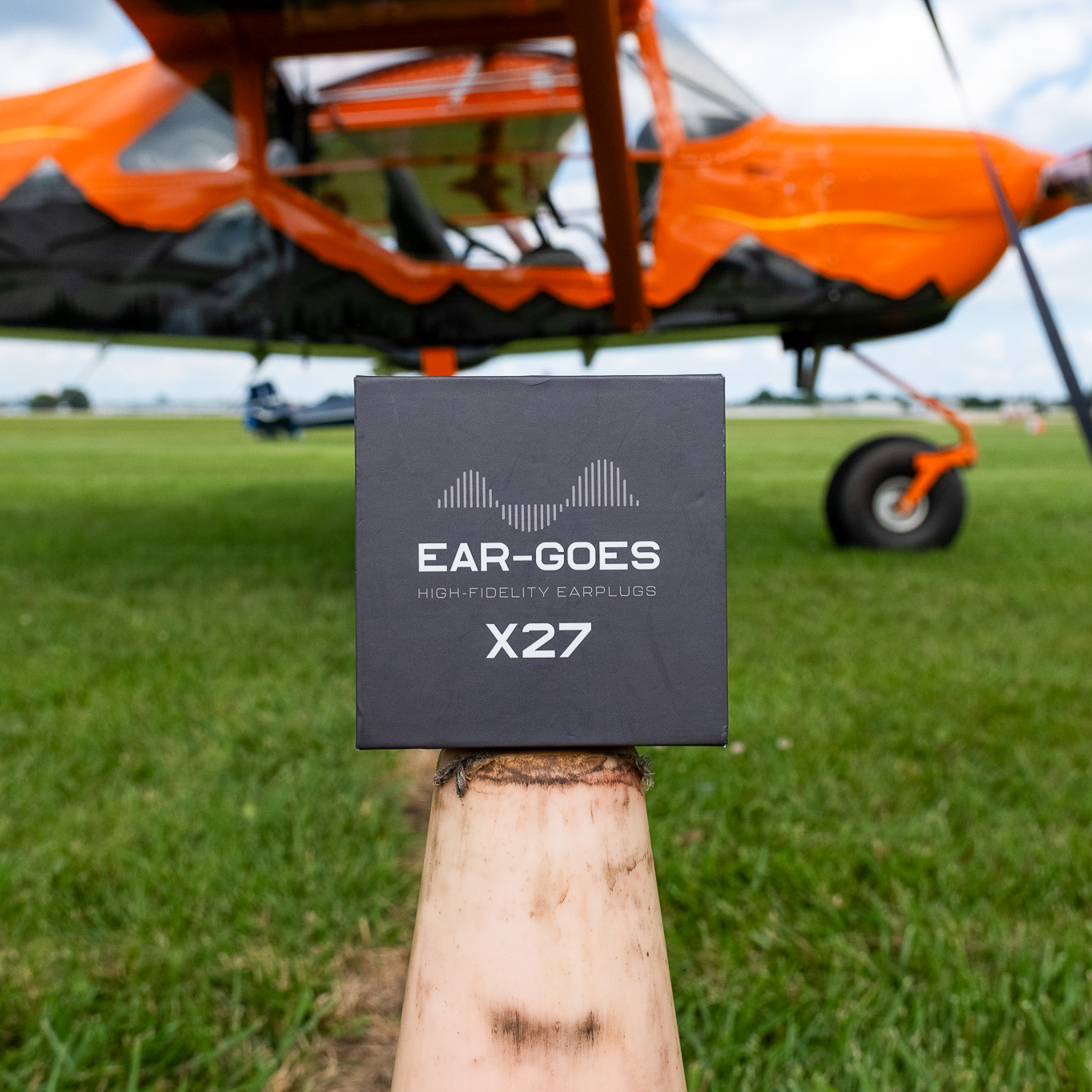 Ear-Goes aviation earplugs next to a bush plane