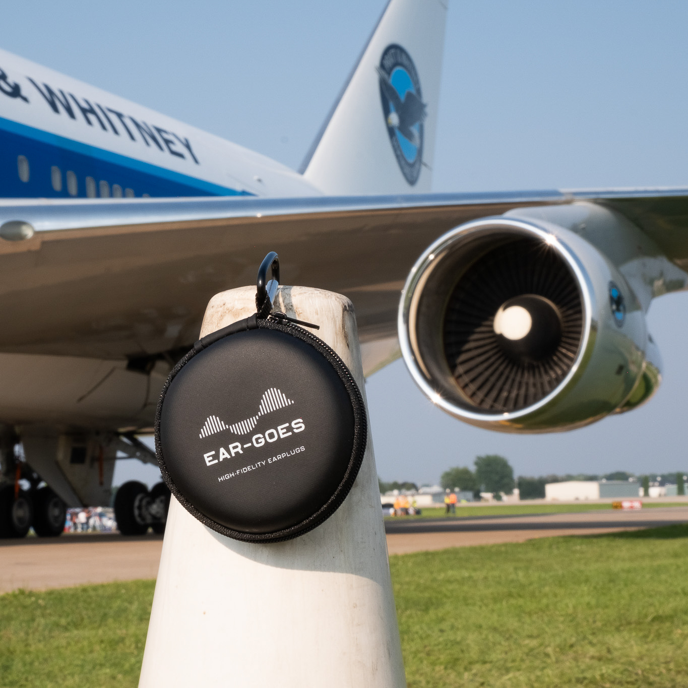 Ear-Goes aviation earplugs near jet plane