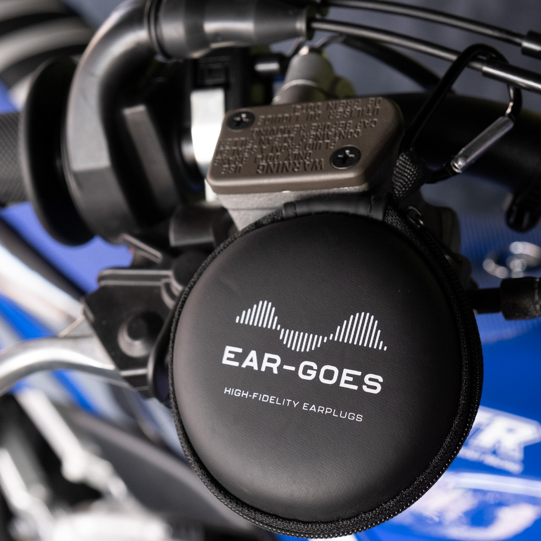 Ear-Goes earplug case on a dirt bike