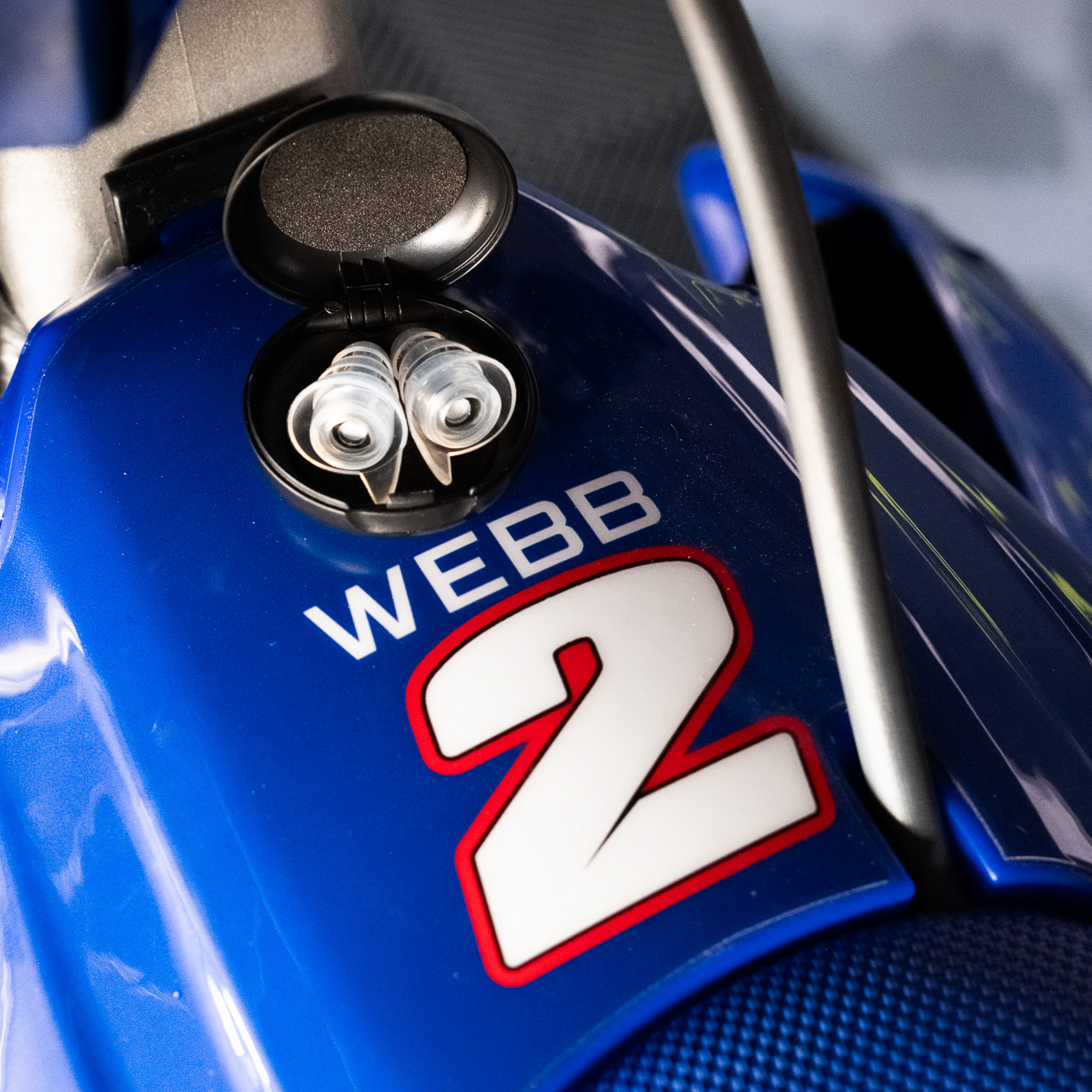 A pair of Ear-Goes earplugs in an open case on a dirt bike