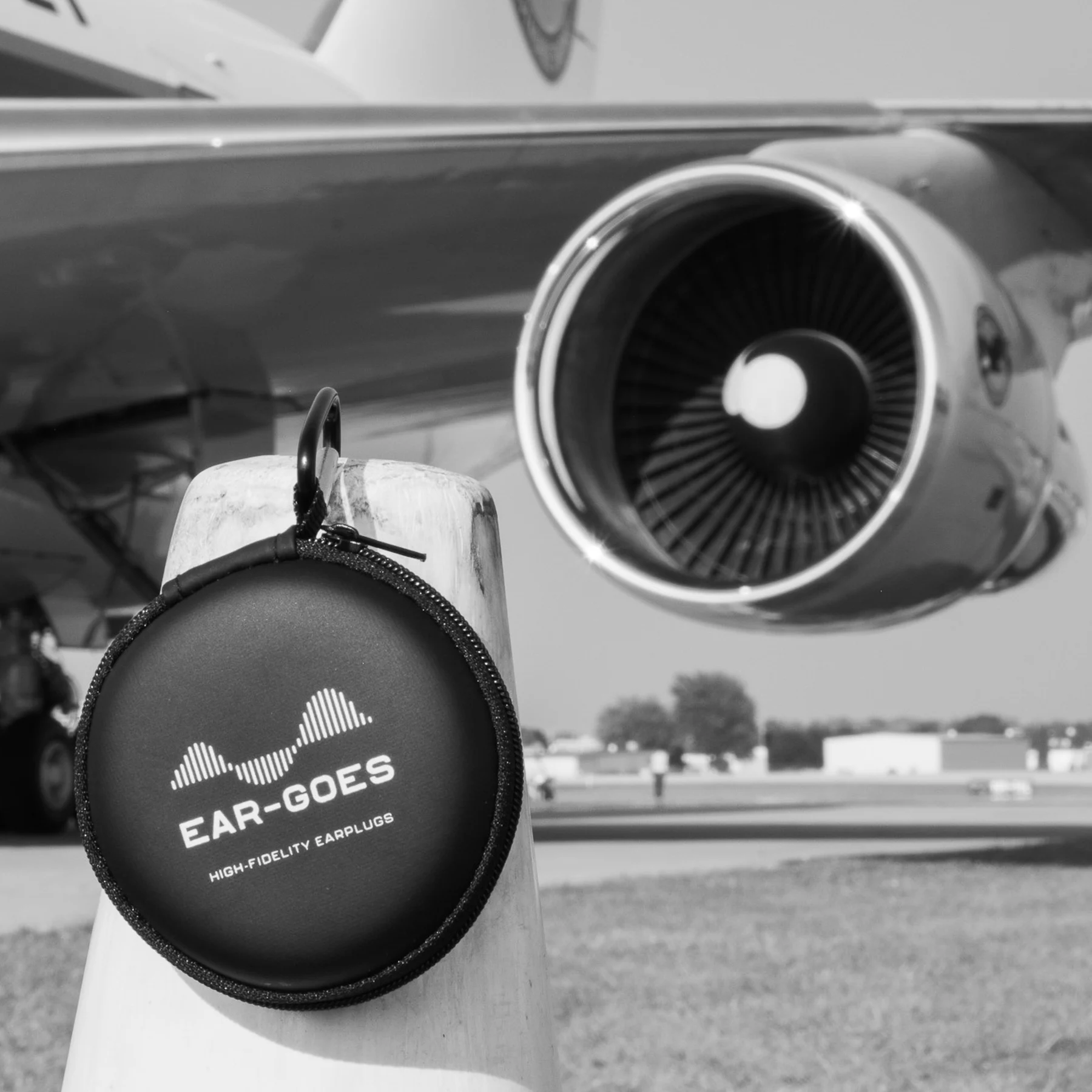 Ear-Goes aviation earplugs next to a jet engine